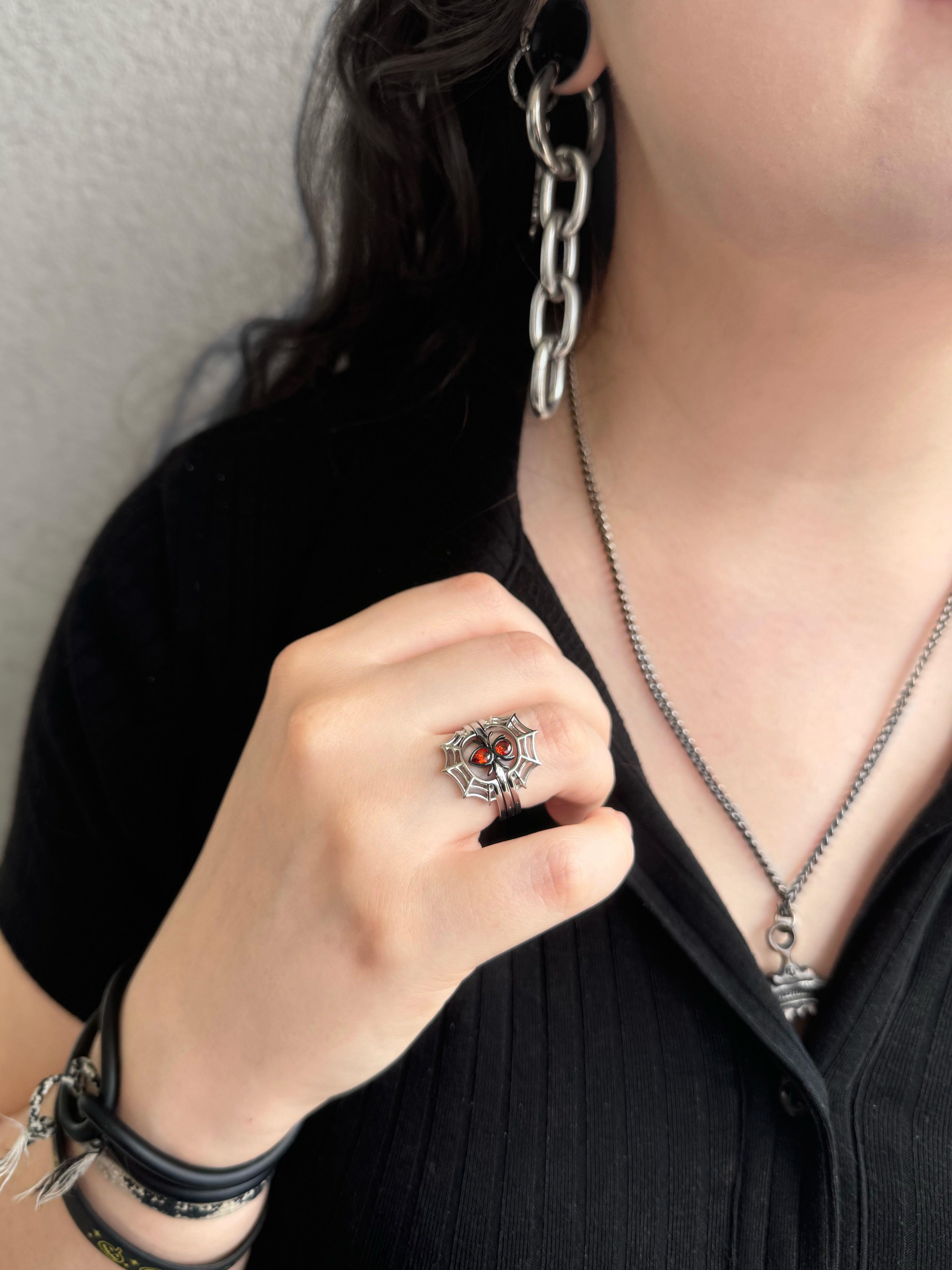 Girl wearing silver spider and web rings together as a stack